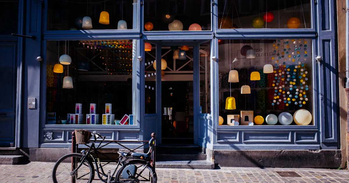 Local business storefront with illuminated window display, representing online presence with Google Business Profile