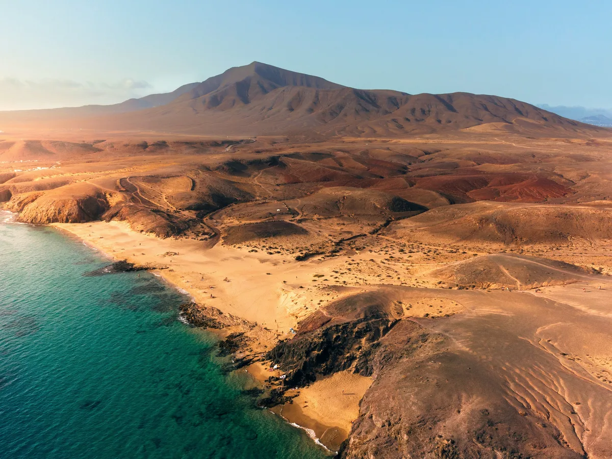 Golden sand of a Lanzarote beach, origin of the brand's amber