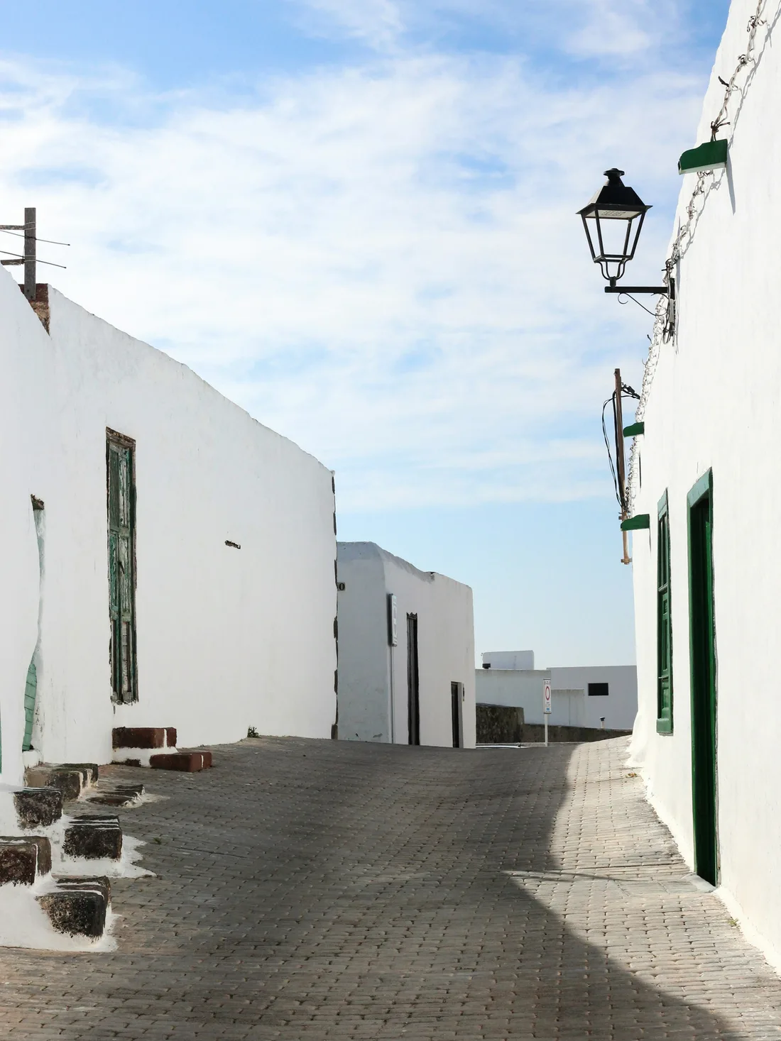 Street of whitewashed houses in Lanzarote, origin of the brand's white