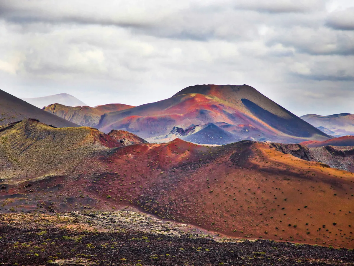 Volcano in Lanzarote with its lava field, origin of the brand's volcanic dot